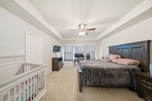 a bedroom with a bed and ceiling chandelier