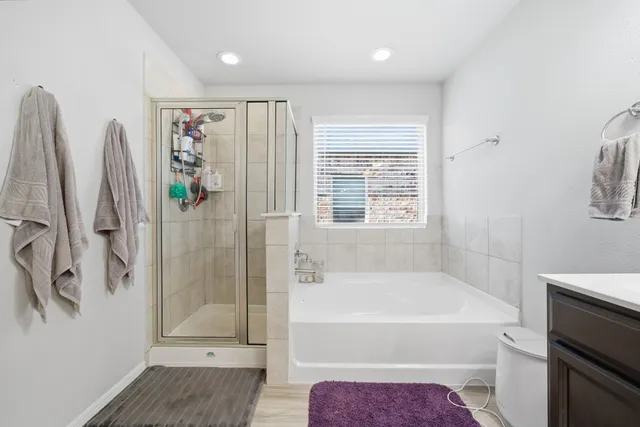 a bathroom with a bathtub and a shower