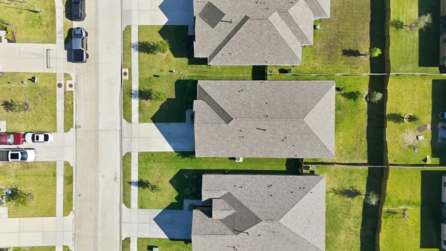 an aerial view of a house with a yard