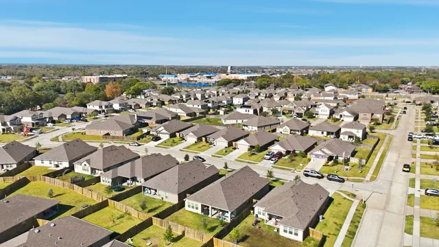 an aerial view of residential building with green space