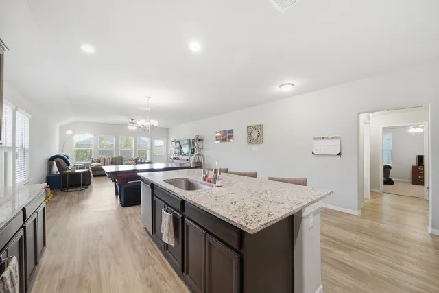 a open kitchen with stainless steel appliances granite countertop a lot of counter space and wooden floor