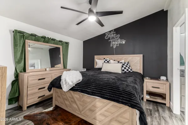 a bedroom with a bed and a chandelier