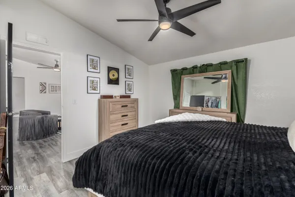 a bedroom with a bed and a mirror