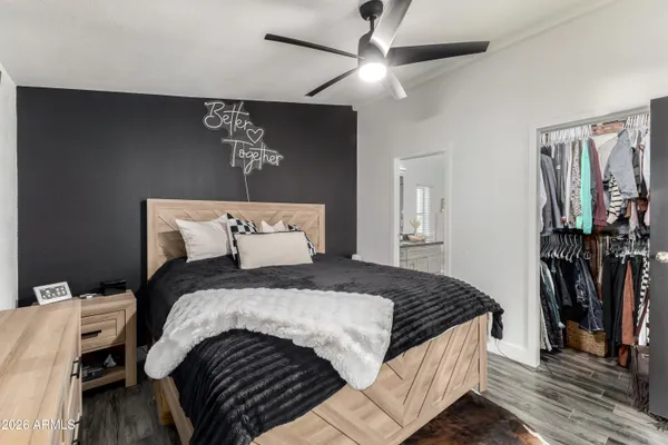 a bedroom with bed and wooden floor