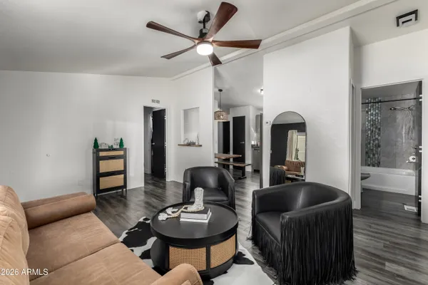 a living room with furniture a wooden floor and a chandelier
