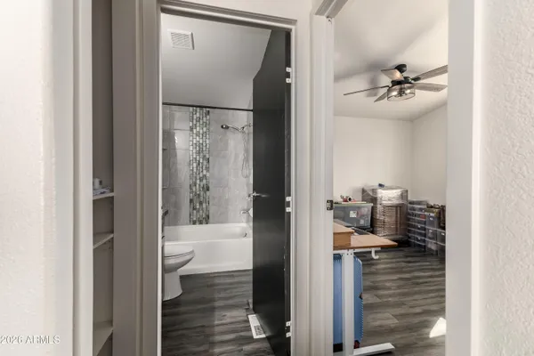 a bathroom with a glass door shower and a bathroom