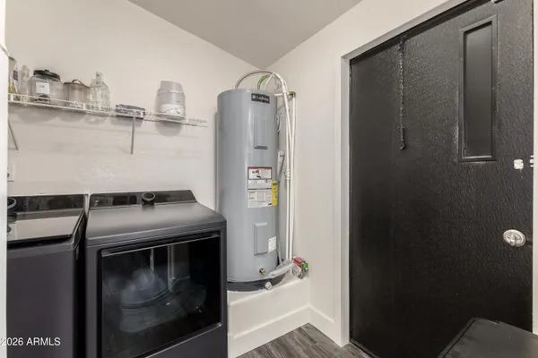 a utility room with cabinets and washer