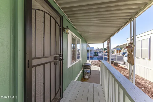 a view of a balcony with wooden floor