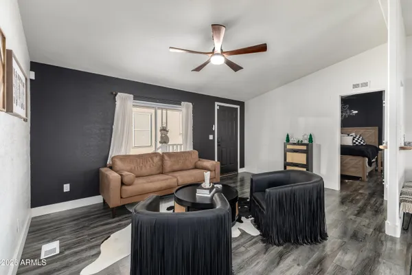 a living room with furniture and a ceiling fan
