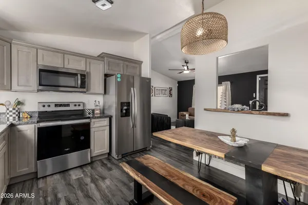 a kitchen with stainless steel appliances a stove microwave and refrigerator