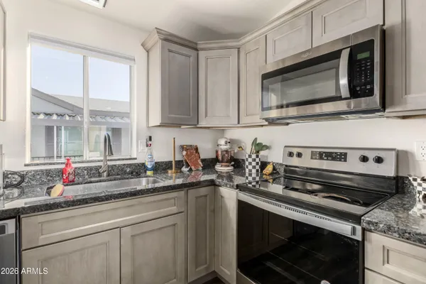a kitchen with a stove microwave and sink