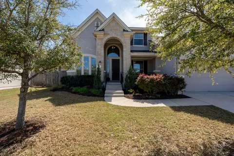 a view of a house with yard and tree s
