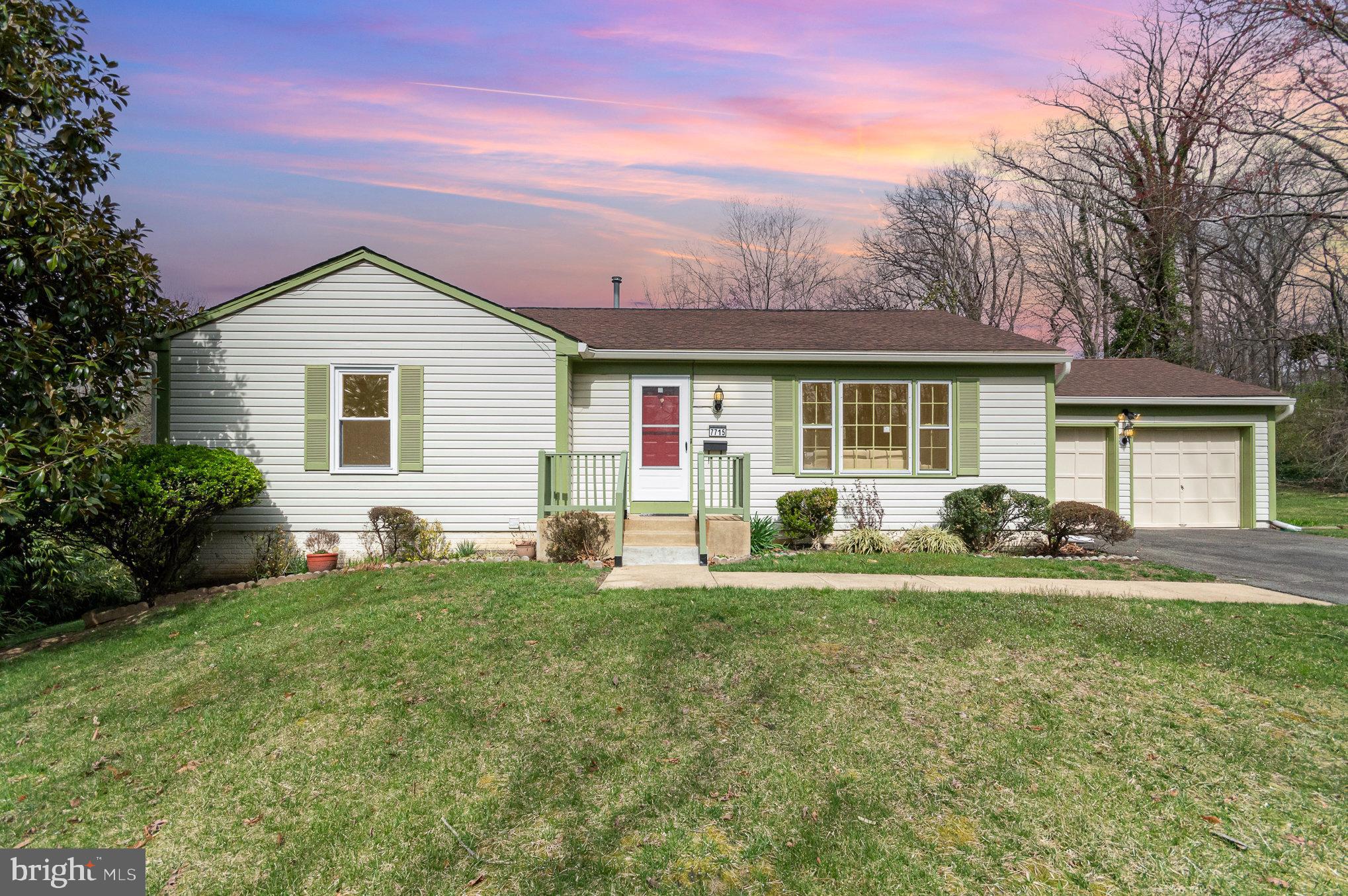 a front view of house with yard and green space