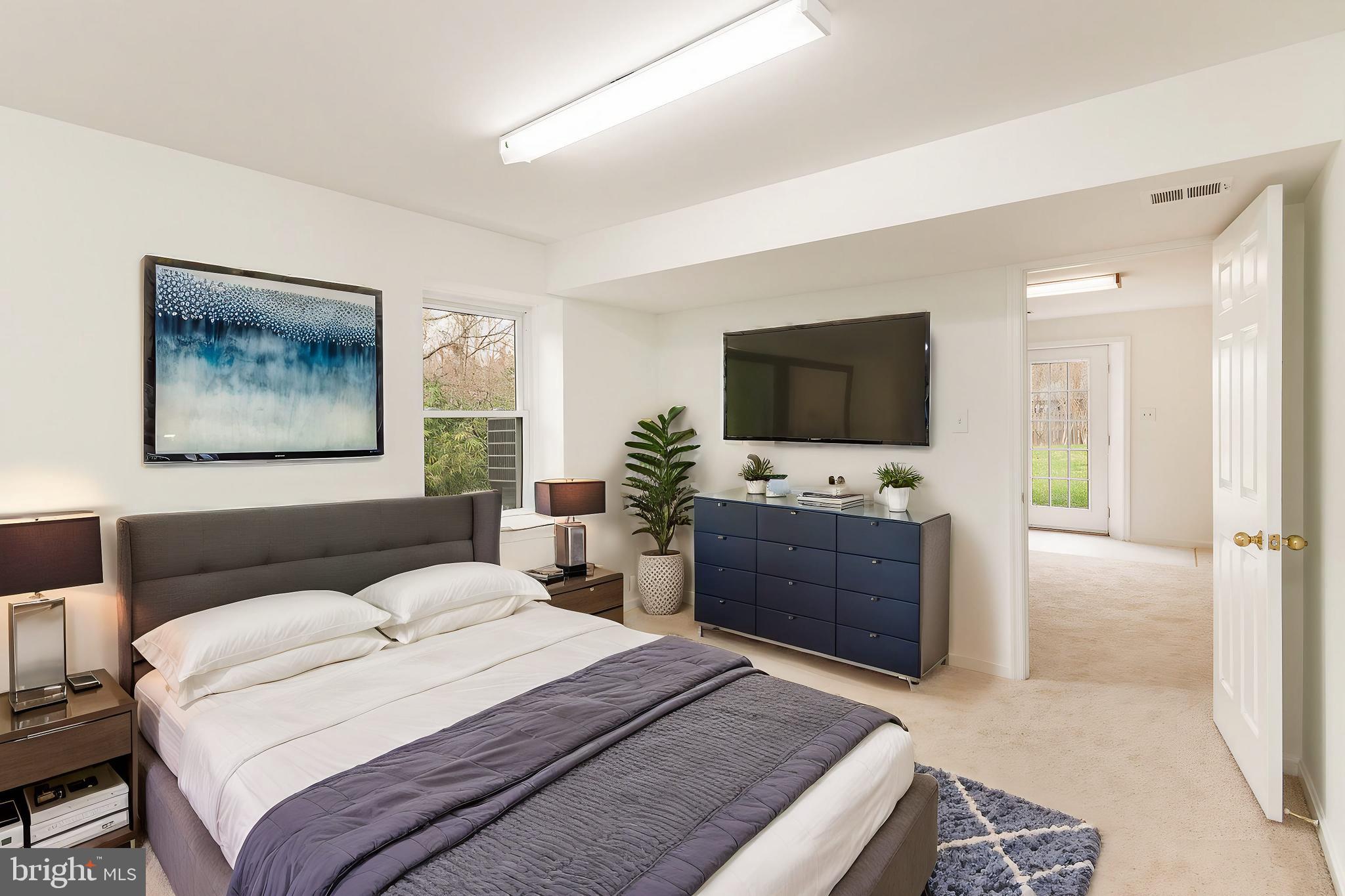 7715 Fort Hunt Road Alexandria, VA 22308 - Photo 15 of 21 a bedroom with a bed and a flat screen tv