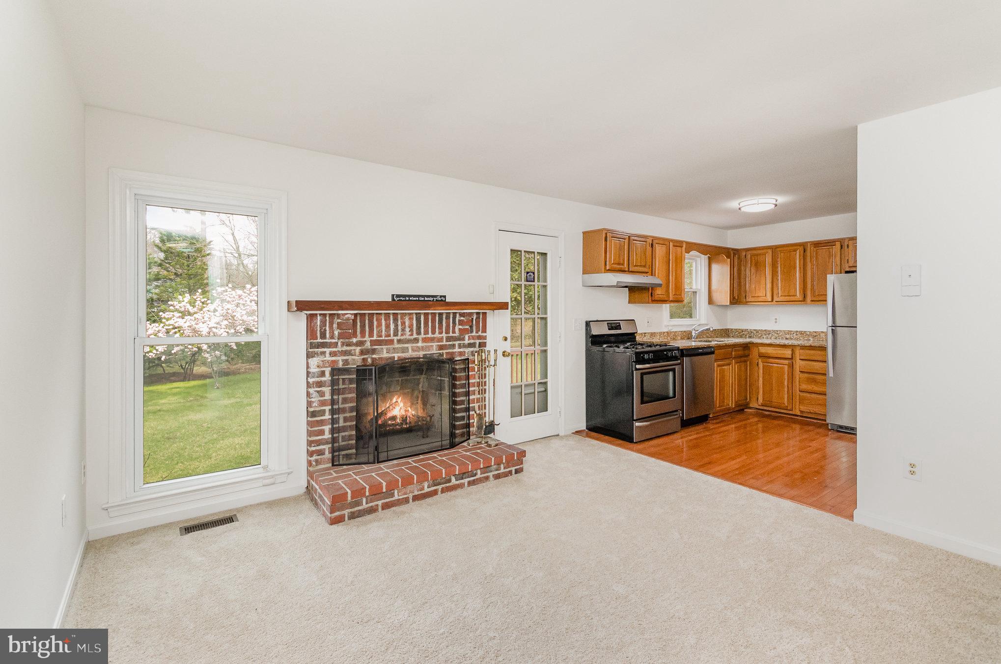 7715 Fort Hunt Road Alexandria, VA 22308 - Photo 8 of 21 a view of a kitchen with furniture and a fireplace