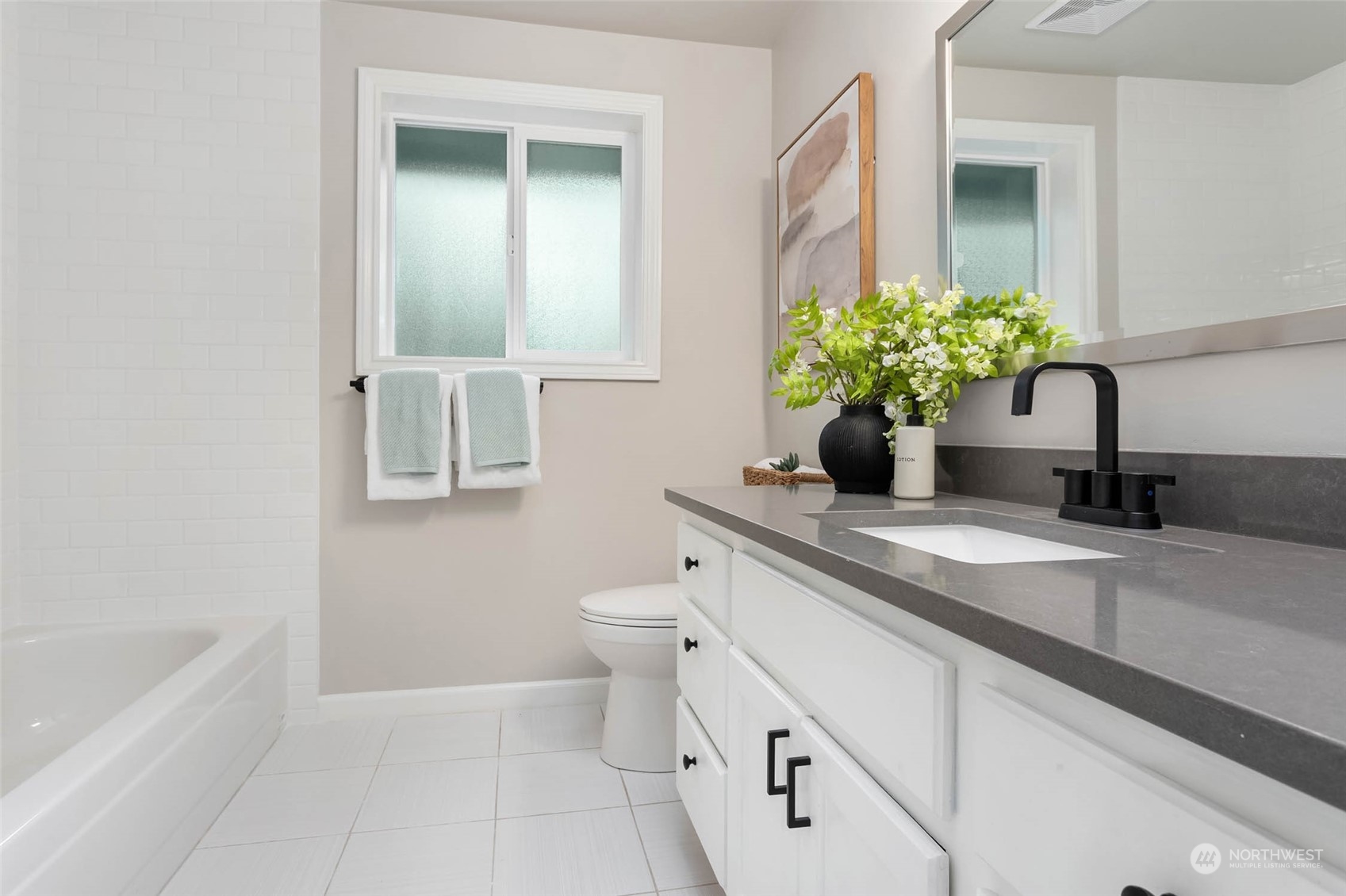 18604 29th Avenue Southeast Bothell, WA 98012 - Photo 26 of 40 a bathroom with a granite countertop toilet a sink and mirror