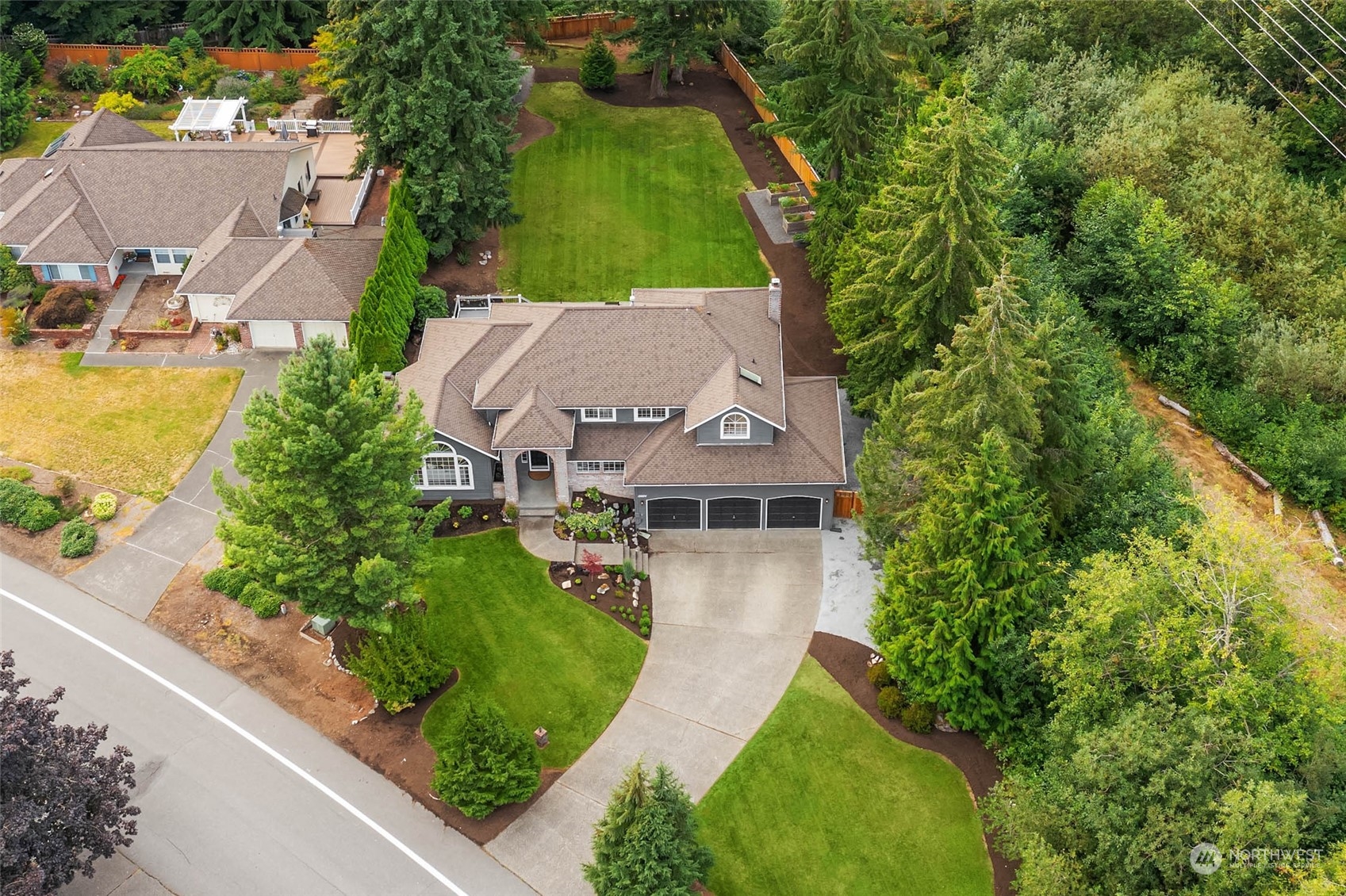 18604 29th Avenue Southeast Bothell, WA 98012 - Photo 3 of 40 an aerial view of a house with a garden and swimming pool