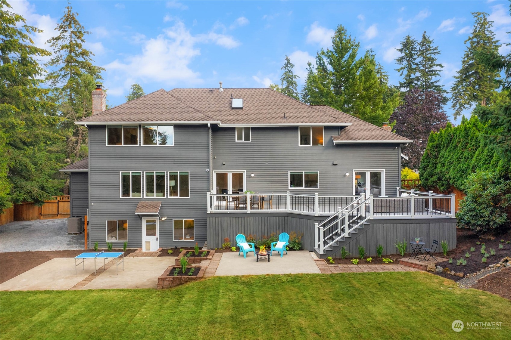 18604 29th Avenue Southeast Bothell, WA 98012 - Photo 9 of 40 a front view of a house with a yard patio and fire pit
