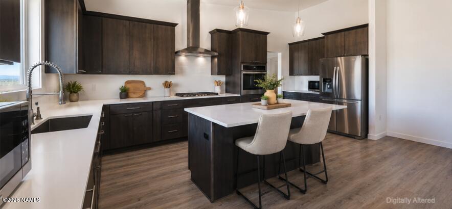 10272 Fw Mclure Road Flagstaff, AZ 86004 - Photo 3 of 38 a kitchen with stainless steel appliances a dining table chairs refrigerator and sink