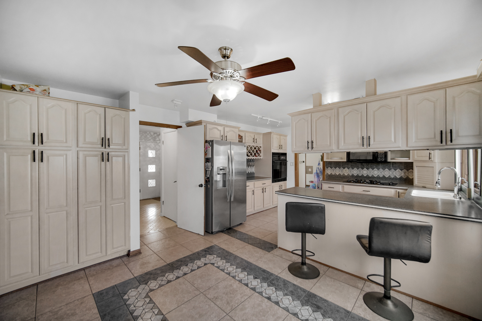2945 Bob O Link Road Flossmoor, IL 60422 - Photo 11 of 24 a kitchen with stainless steel appliances granite countertop a refrigerator a stove a sink and white cabinets
