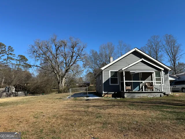 a view of a house with a yard covered in snow
