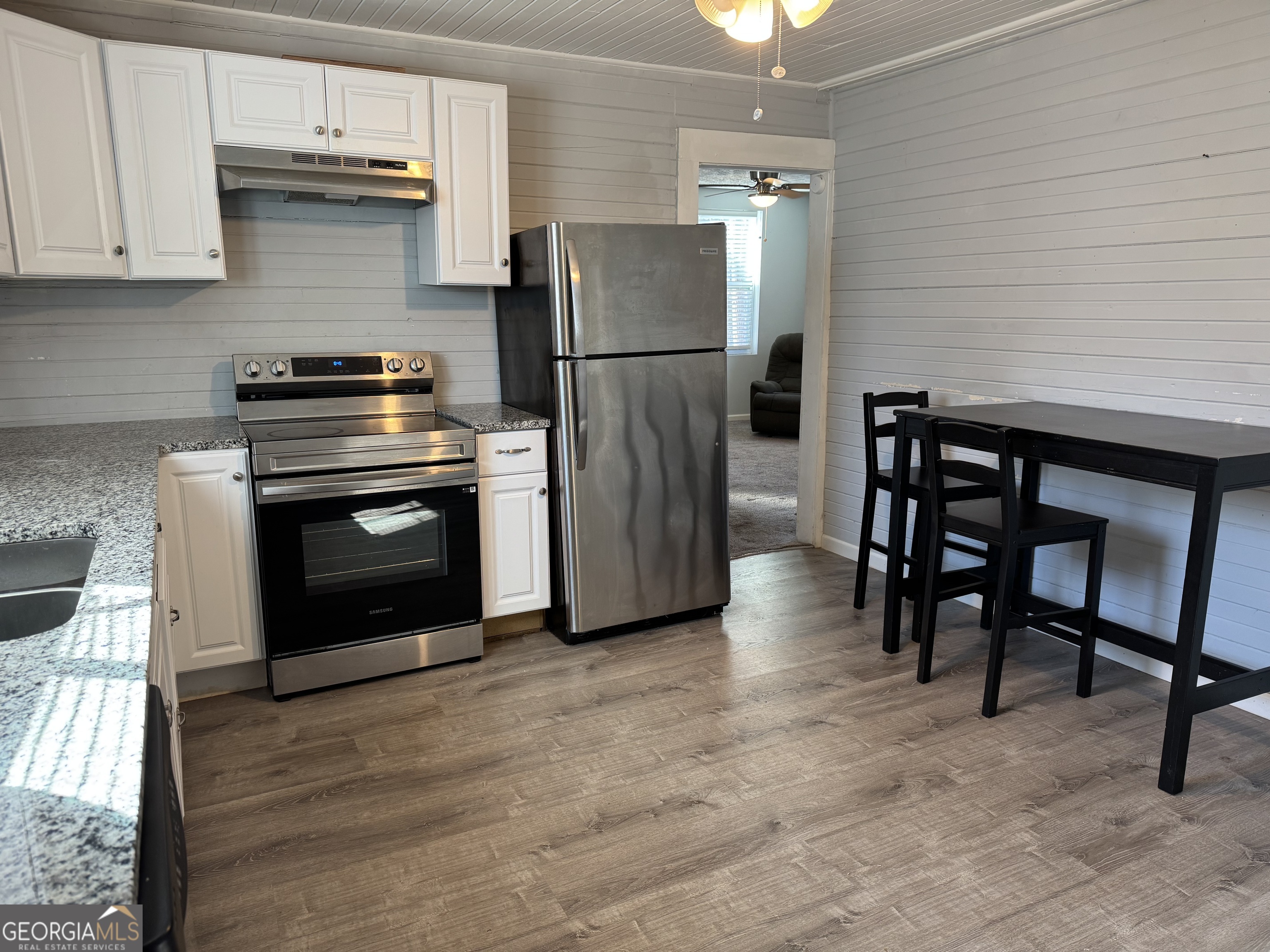 406 Shankle Road Commerce, GA 30529 - Photo 7 of 19 a kitchen with stainless steel appliances granite countertop a refrigerator a stove and a sink with granite countertops