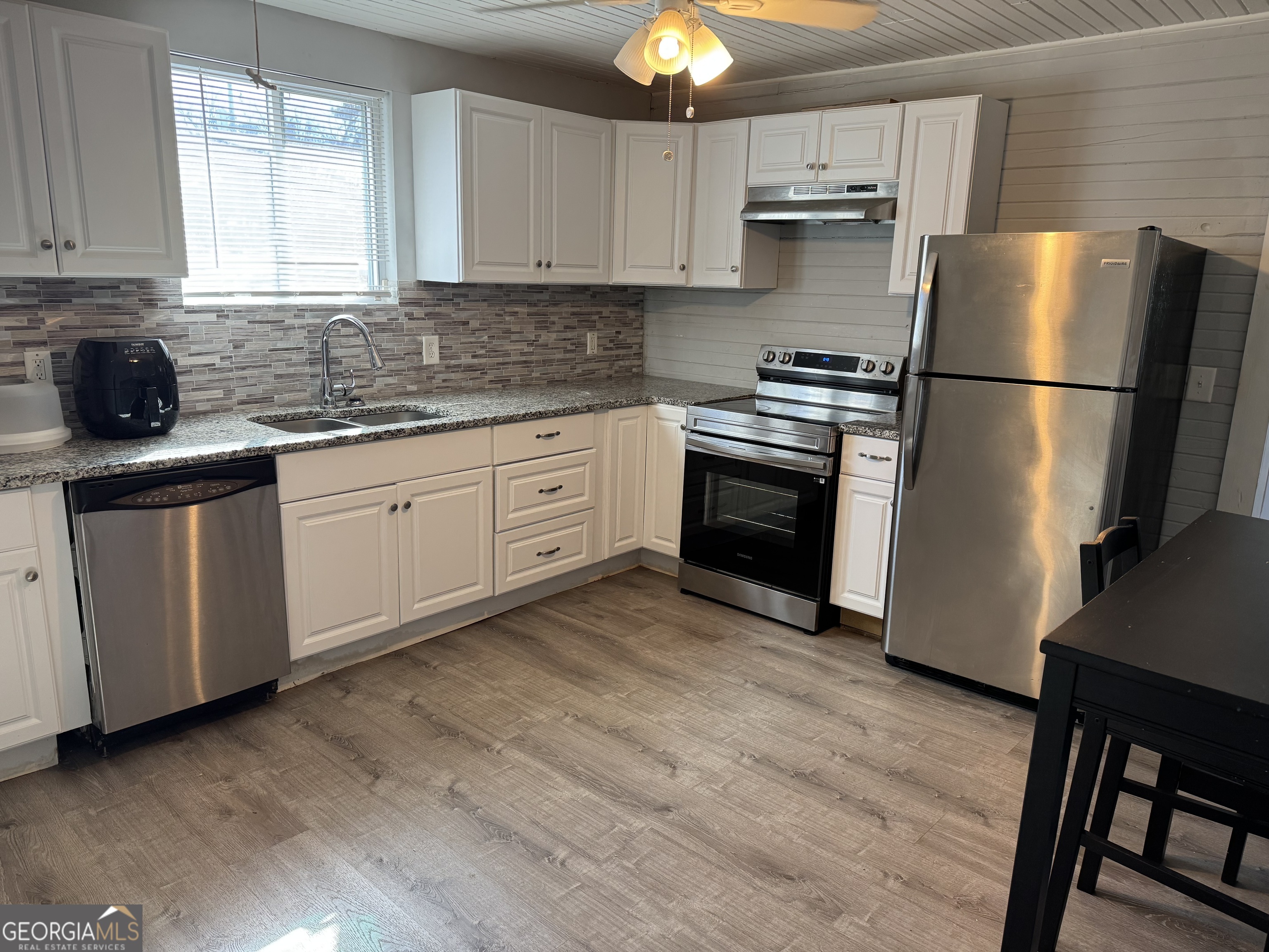 406 Shankle Road Commerce, GA 30529 - Photo 9 of 19 a kitchen with stainless steel appliances granite countertop a refrigerator sink and stove