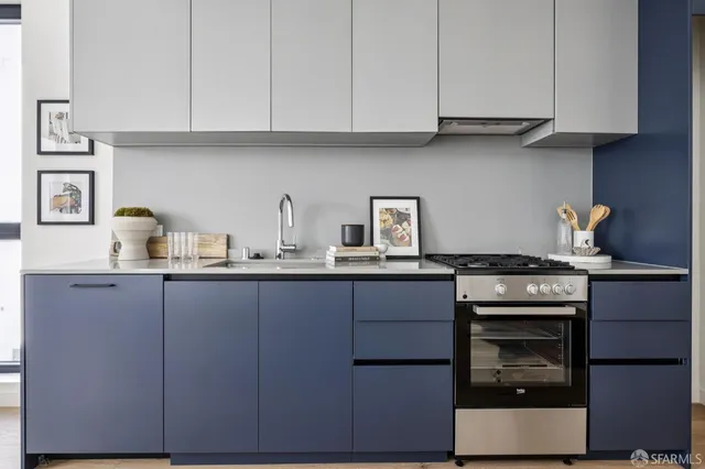 a kitchen with cabinets appliances and a sink