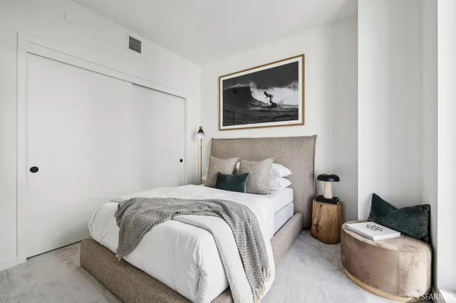 a bedroom with a bed and a couch