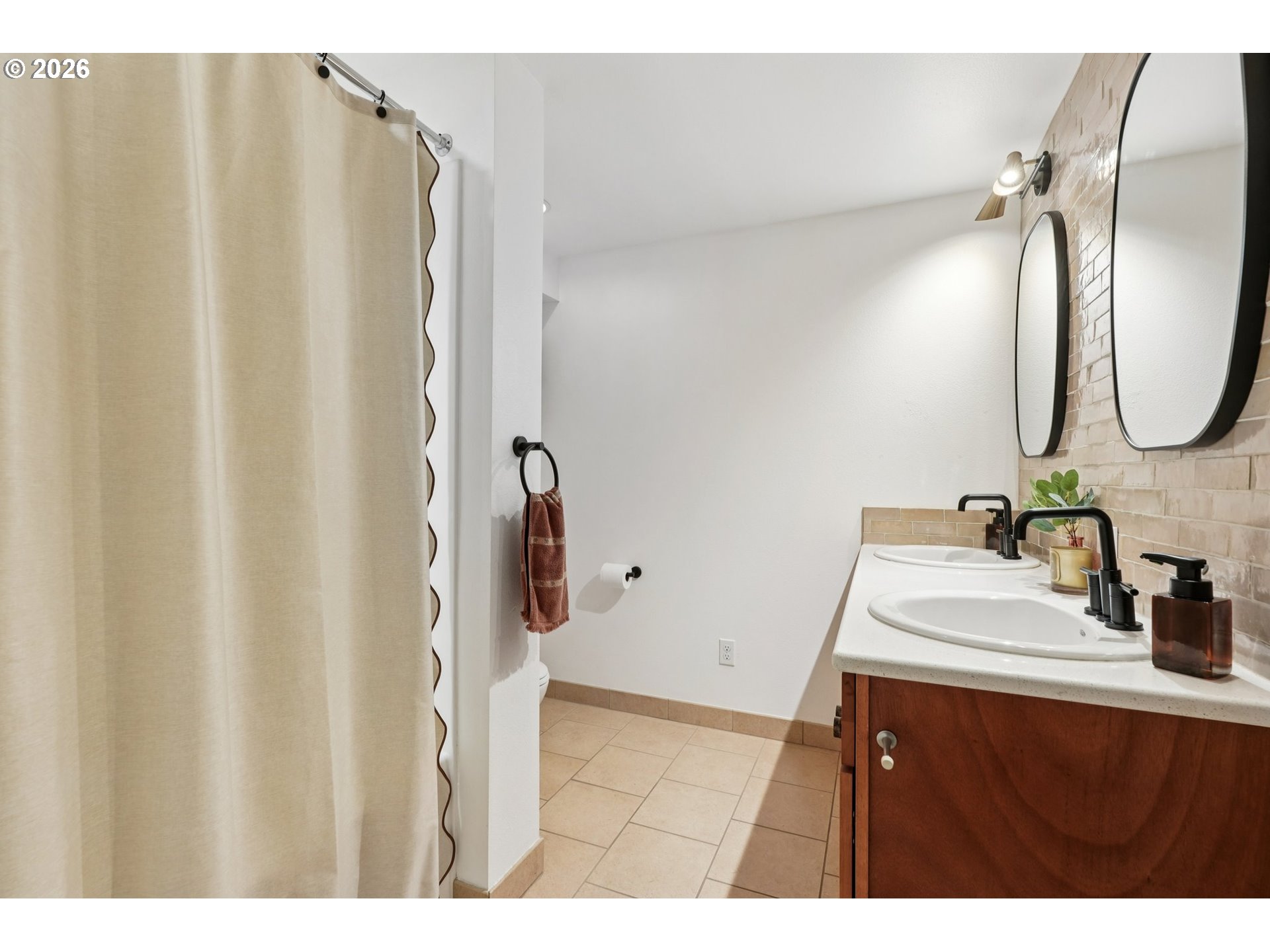 7225 Southwest 13th Avenue Portland, OR 97219 - Photo 31 of 48 a bathroom with a sink and mirror
