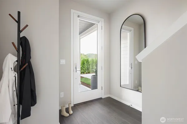 a view of front door with wooden floor