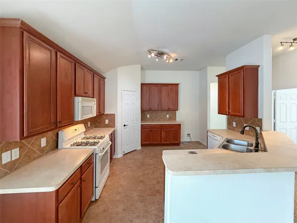 a kitchen that has a sink and a stove in it