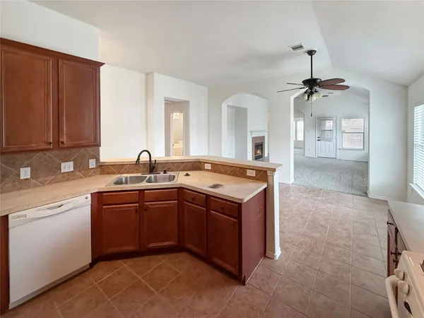 a kitchen with stainless steel appliances granite countertop a sink and cabinets