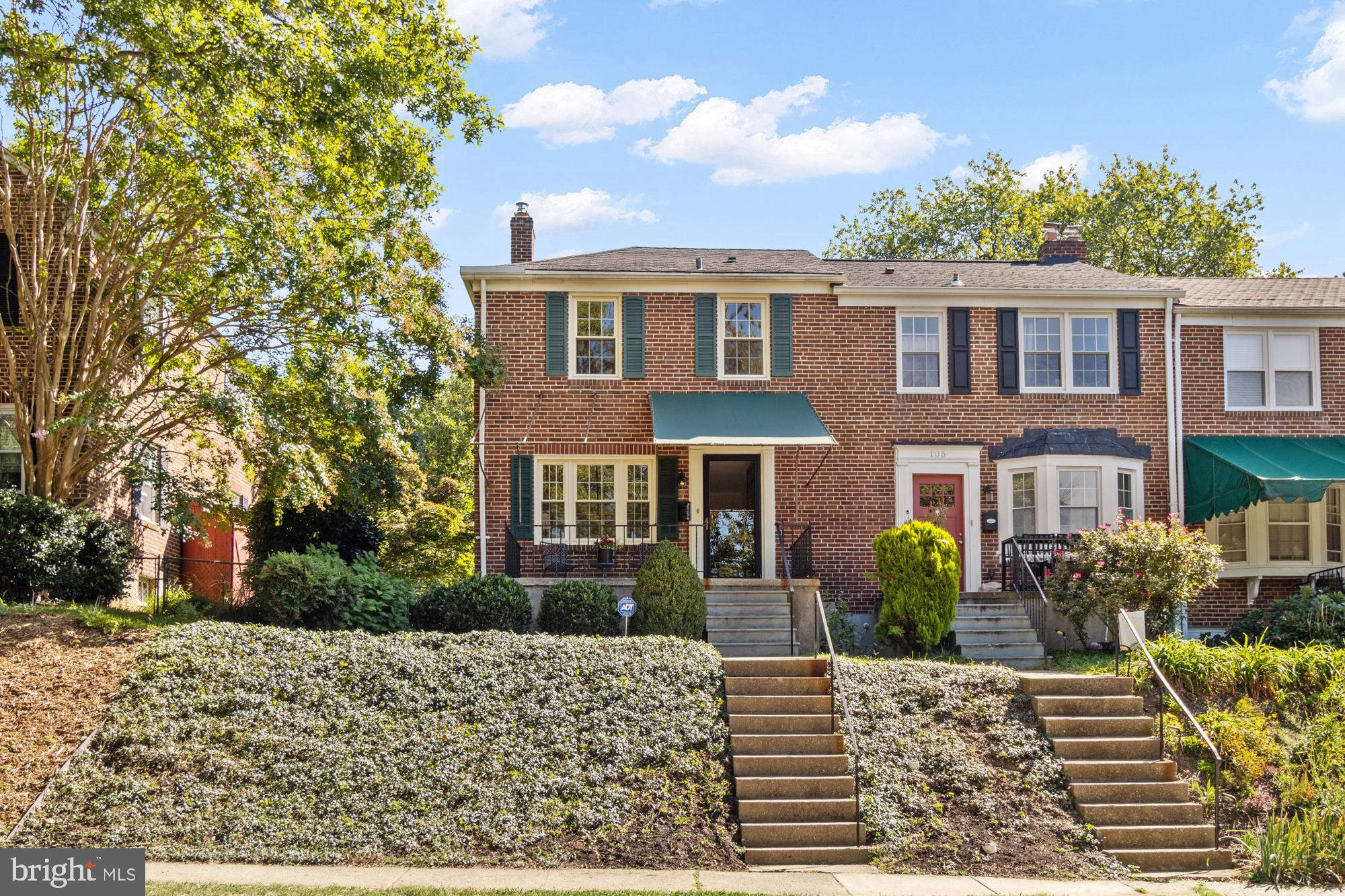 107 Stanmore Road Baltimore, MD 21212 - Photo 34 of 35 a view of a brick house with a yard and plants