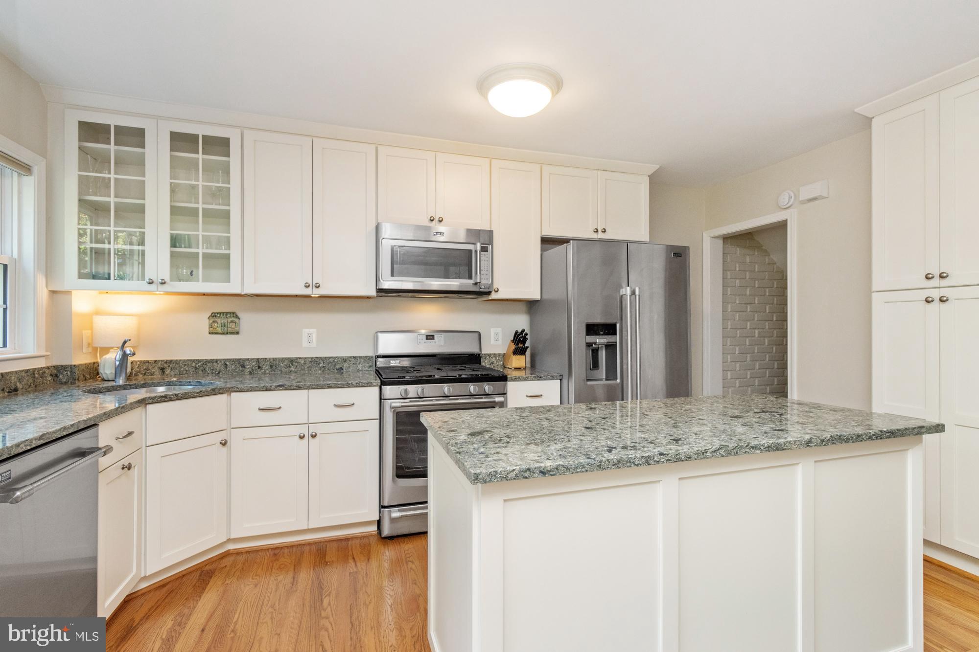 107 Stanmore Road Baltimore, MD 21212 - Photo 4 of 35 a kitchen with stainless steel appliances granite countertop a sink stove and refrigerator
