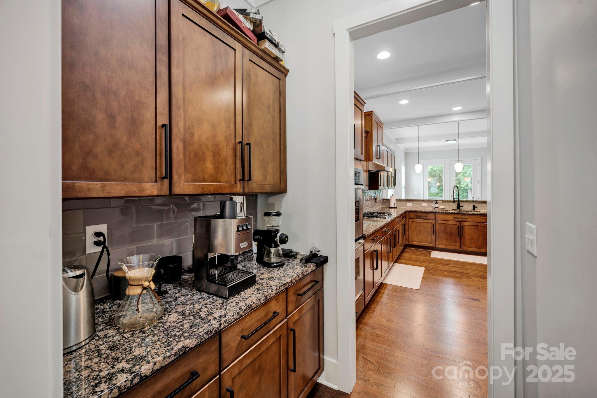 3076 Amaranth Drive Tega Cay, SC 29708 - Photo 13 of 39 a kitchen with granite countertop lots of counter top space and wooden floor