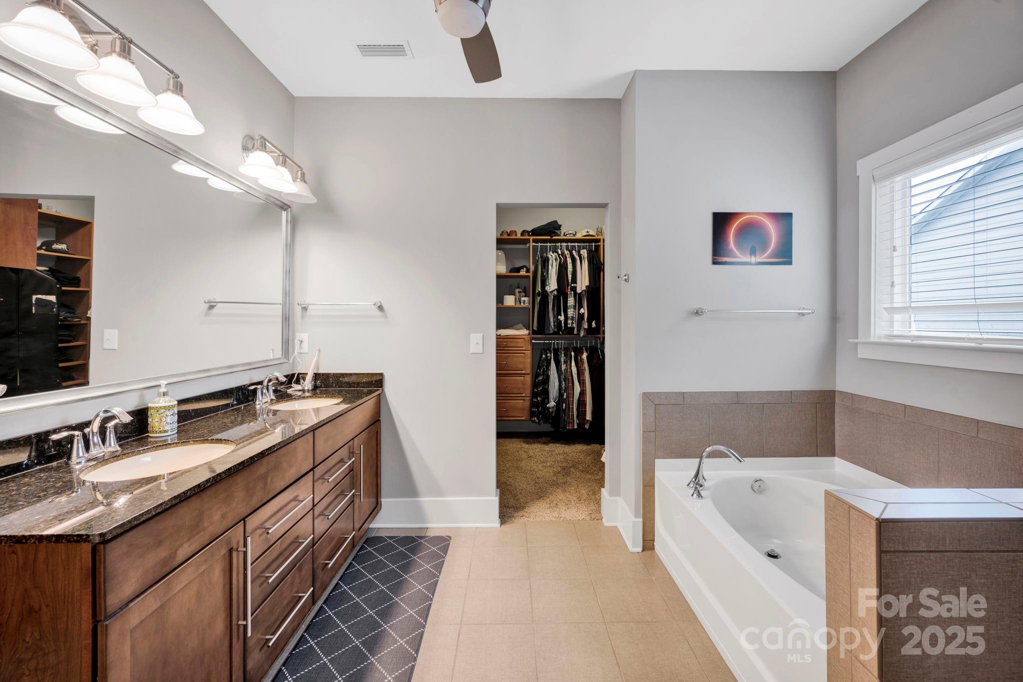 3076 Amaranth Drive Tega Cay, SC 29708 - Photo 20 of 39 a bathroom with a tub sink and mirror