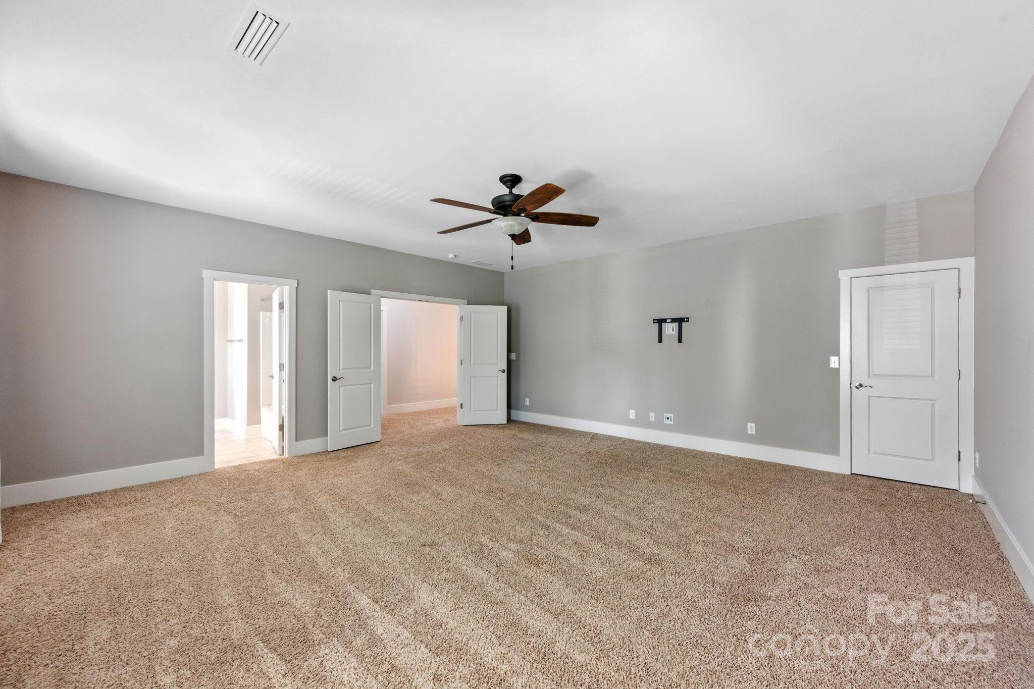 3076 Amaranth Drive Tega Cay, SC 29708 - Photo 25 of 39 a view of an empty room with a ceiling fan