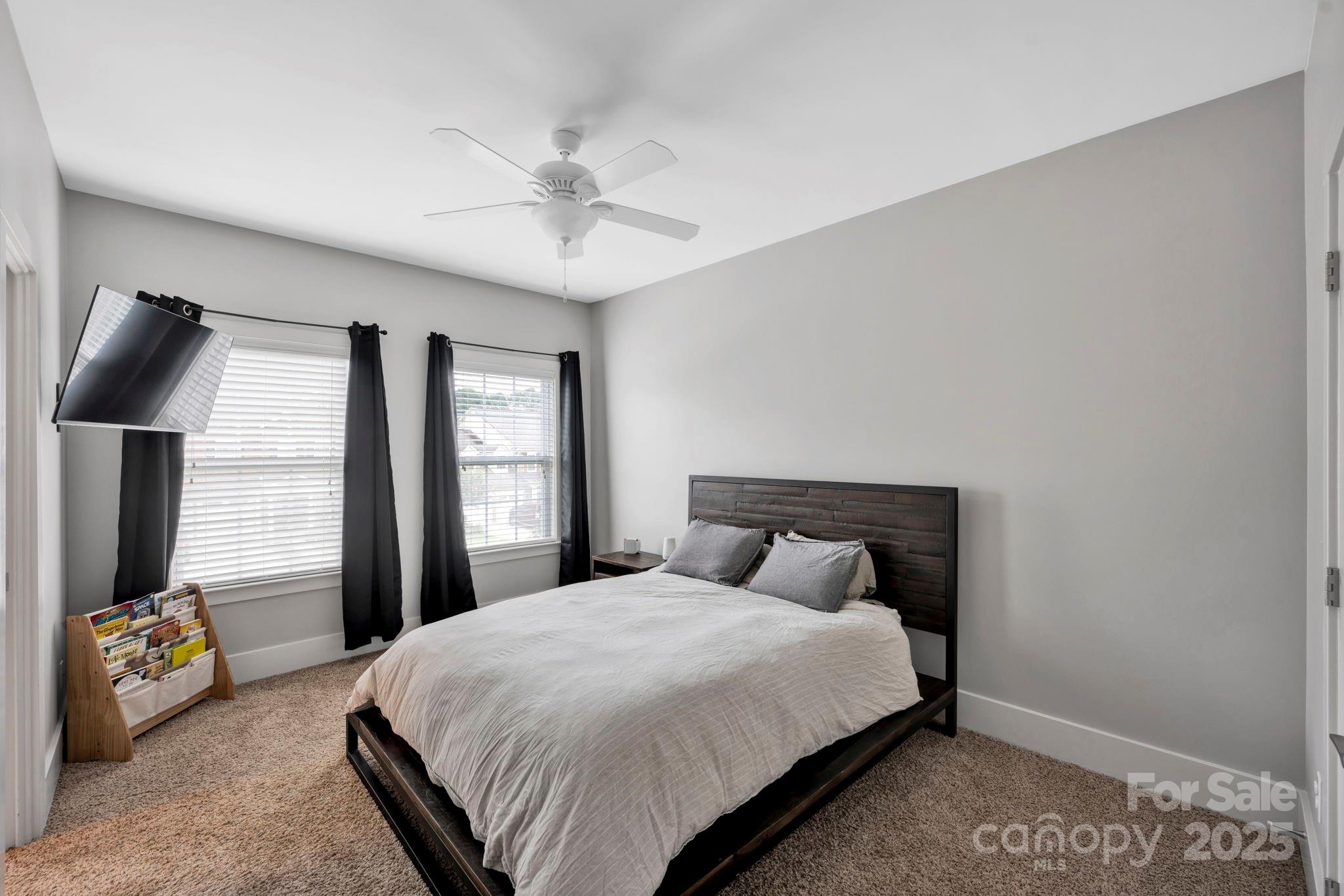 3076 Amaranth Drive Tega Cay, SC 29708 - Photo 26 of 39 a bedroom with a bed and a chandelier