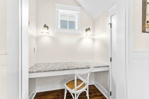 a kitchen with stainless steel appliances granite countertop wooden floors stove and white cabinets