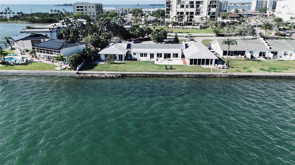 an aerial view of residential houses with outdoor space and swimming pool