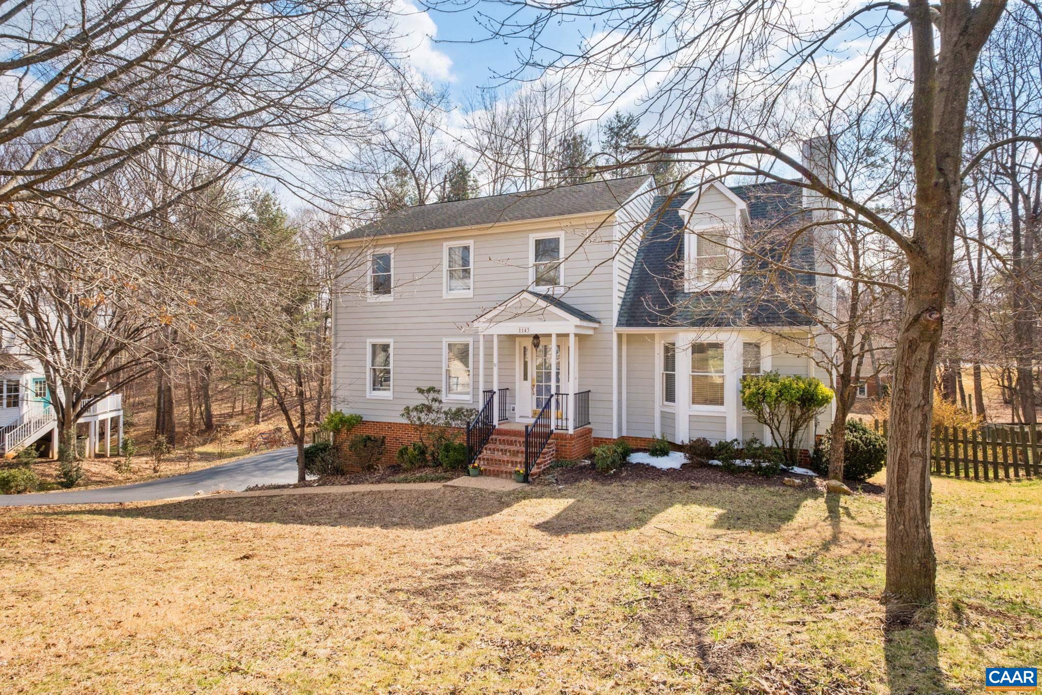 a view of a white house with a yard covered with snow