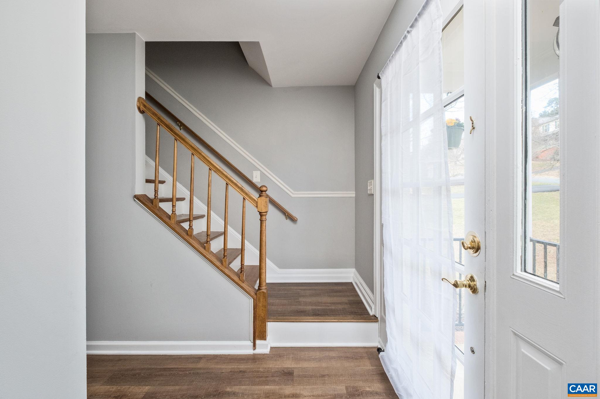 1143 Raintree Drive Charlottesville, VA 22901 - Photo 16 of 49 a view of staircase with wooden floor and a potted plant