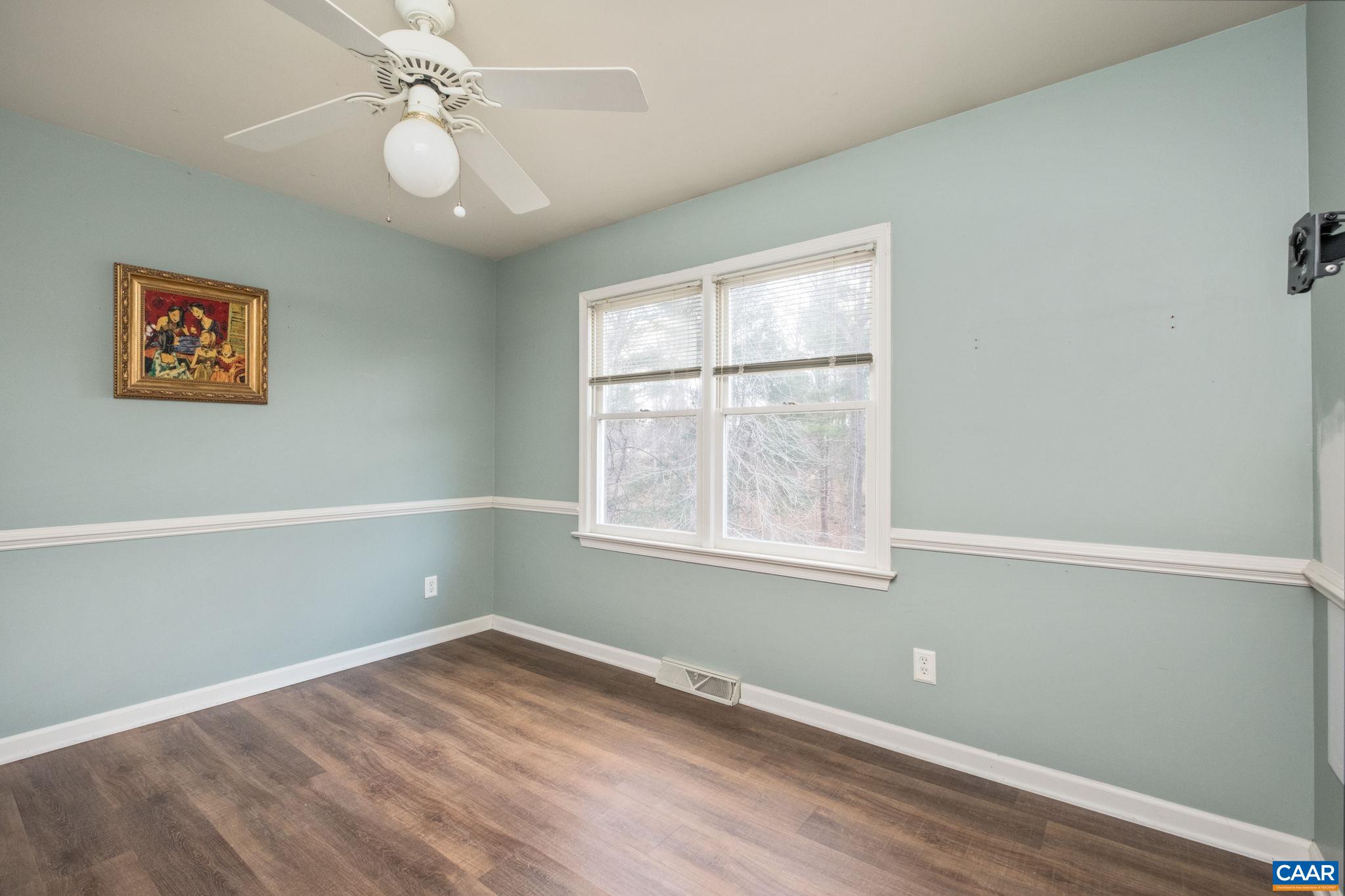 1143 Raintree Drive Charlottesville, VA 22901 - Photo 23 of 49 an empty room with wooden floor fan and windows