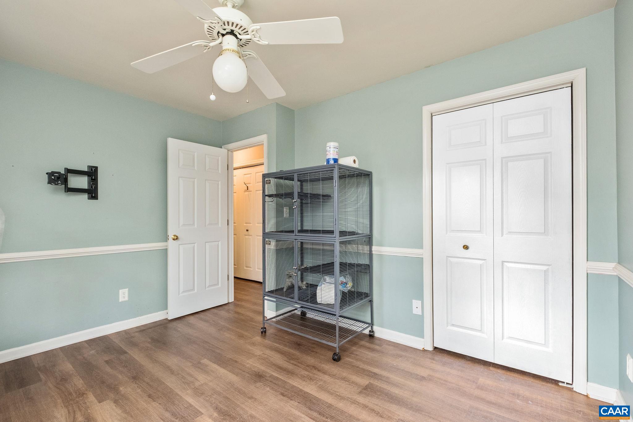 1143 Raintree Drive Charlottesville, VA 22901 - Photo 24 of 49 a view of a room with gym equipment and a chandelier fan