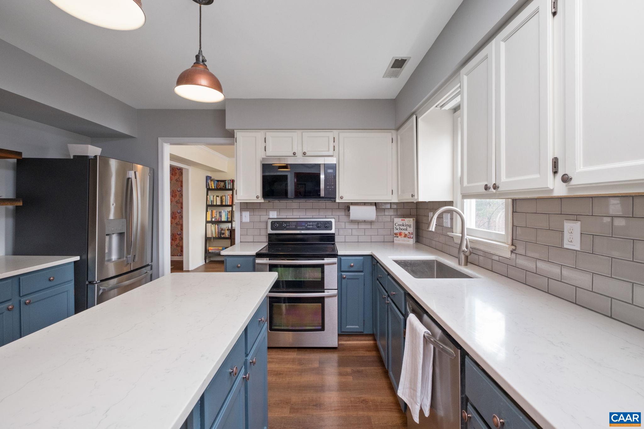 1143 Raintree Drive Charlottesville, VA 22901 - Photo 6 of 49 a kitchen with stainless steel appliances granite countertop a sink stove microwave and refrigerator