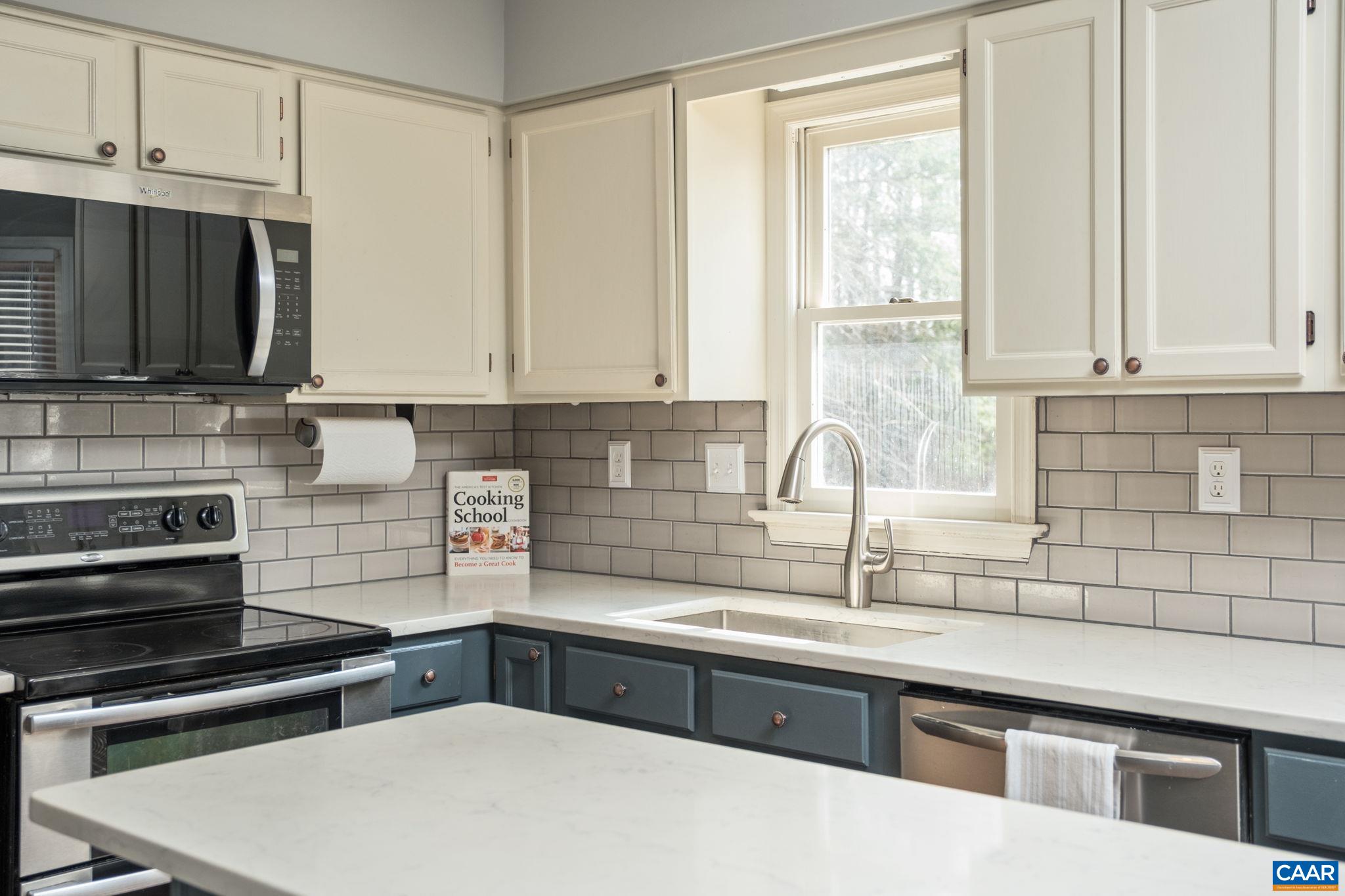 1143 Raintree Drive Charlottesville, VA 22901 - Photo 7 of 49 a kitchen with stainless steel appliances a sink a stove a microwave and cabinets