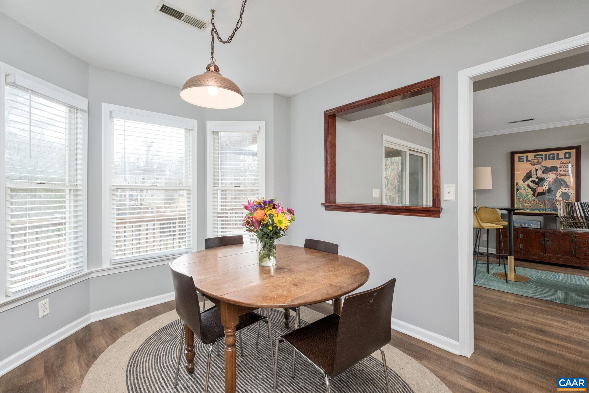 1143 Raintree Drive Charlottesville, VA 22901 - Photo 10 of 49 a view of a dining room with furniture window and wooden floor