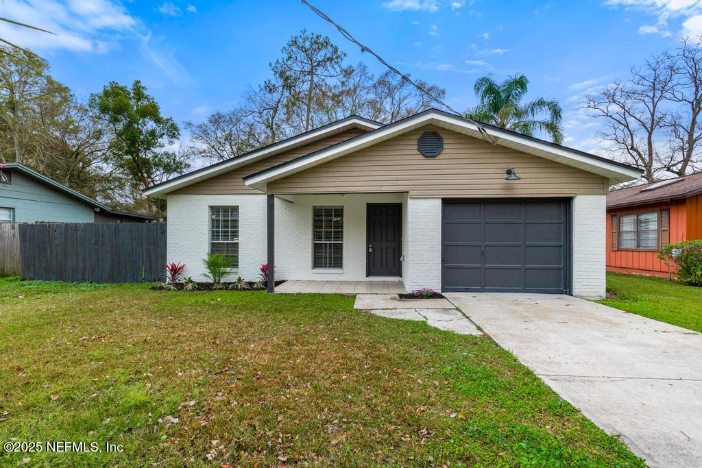 4730 Barnes Road South Jacksonville, FL 32207 - Photo 5 of 47 a front view of a house with a yard and garage