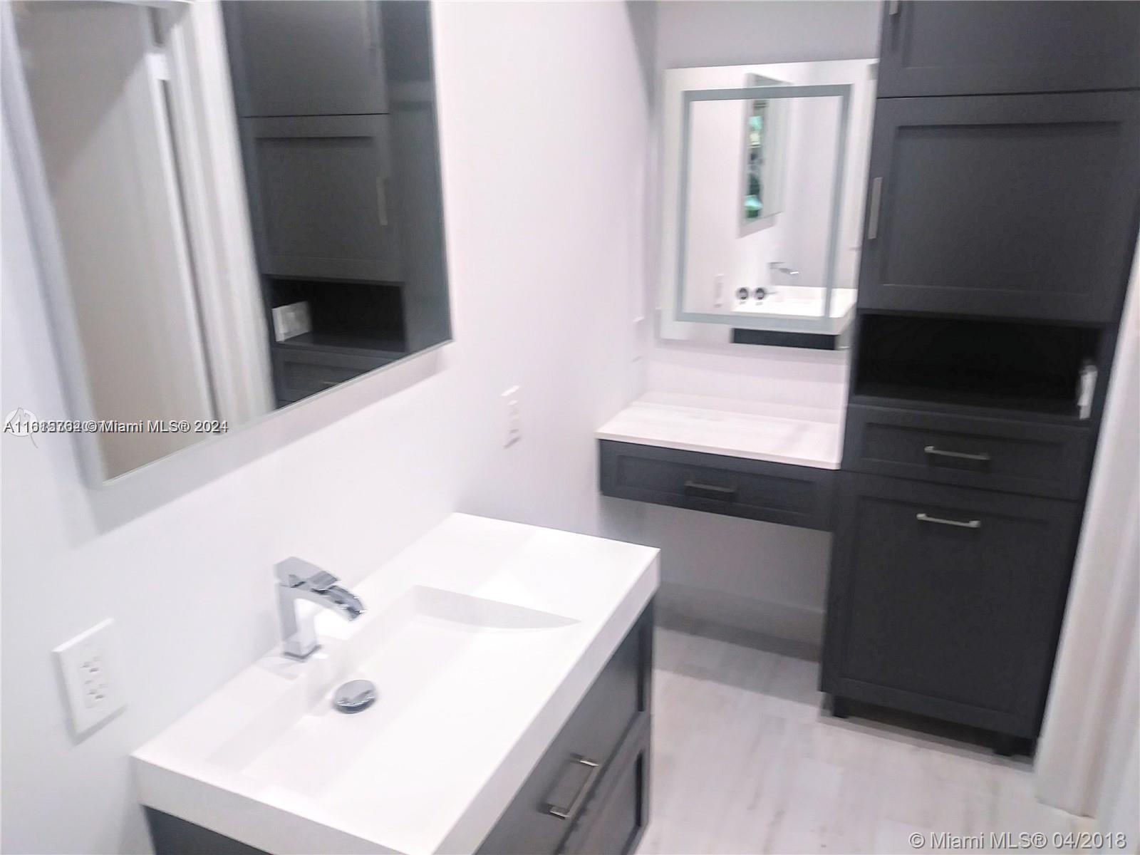 610 Southwest 25th Road Miami, FL 33129 - Photo 14 of 30 a bathroom with a sink and a mirror